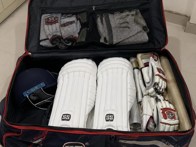 Cricket kit bag with pads and gloves